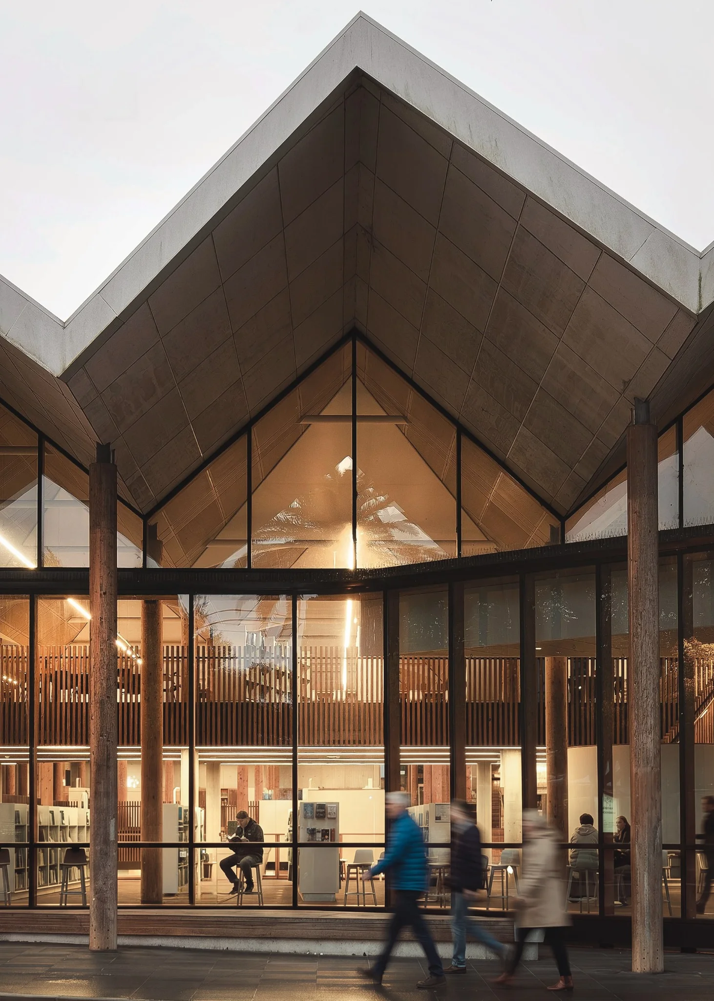Marrickville Library's pitched roof, timber structure and illuminated interior