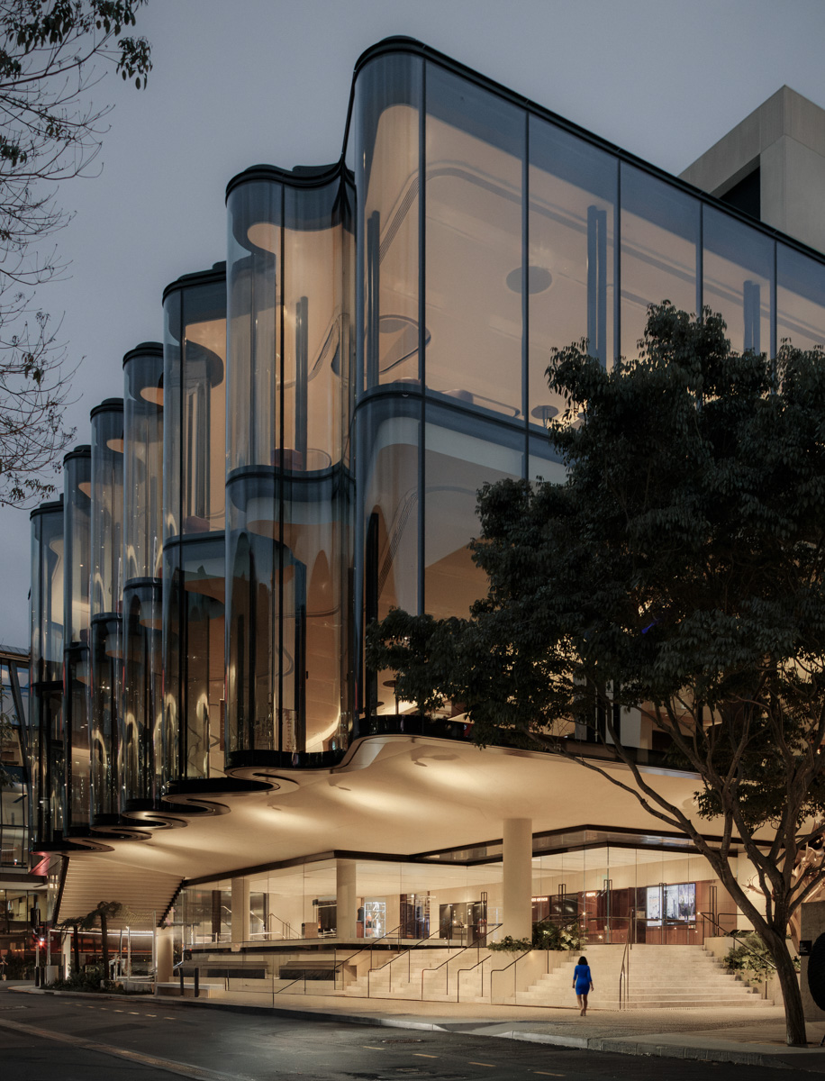 Glasshouse Theatre curved glass facade and entrance at dusk · photography by Jason Romeo